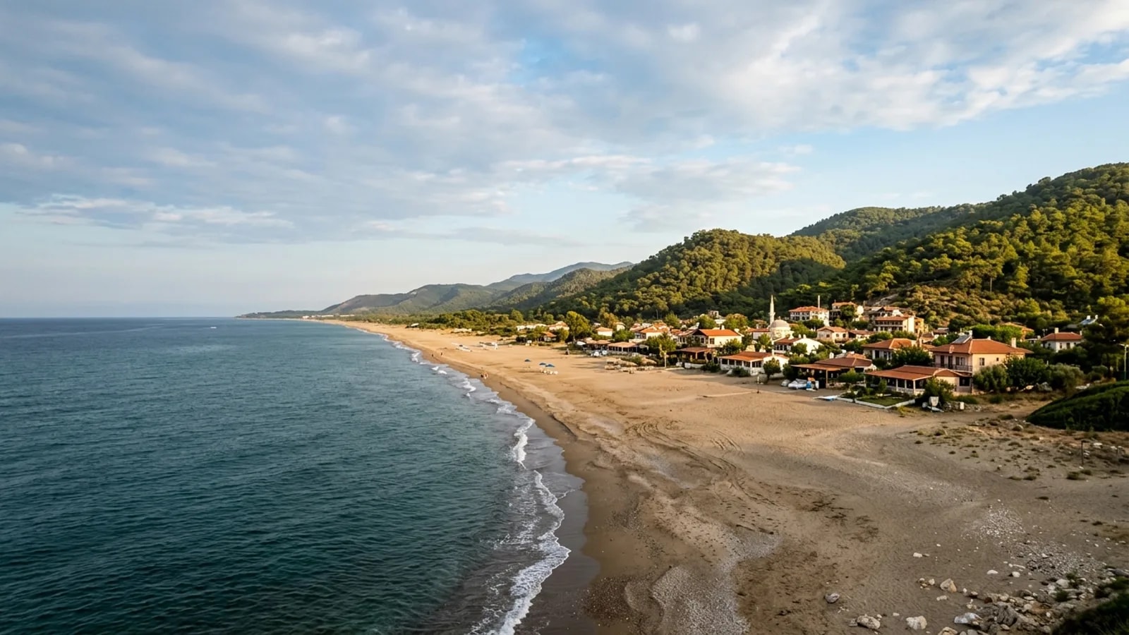Cenger, Türkiye — the small coastal settlement of Cenger east of Manavgat, a sandy beach with low wooded hills rising close behind it.