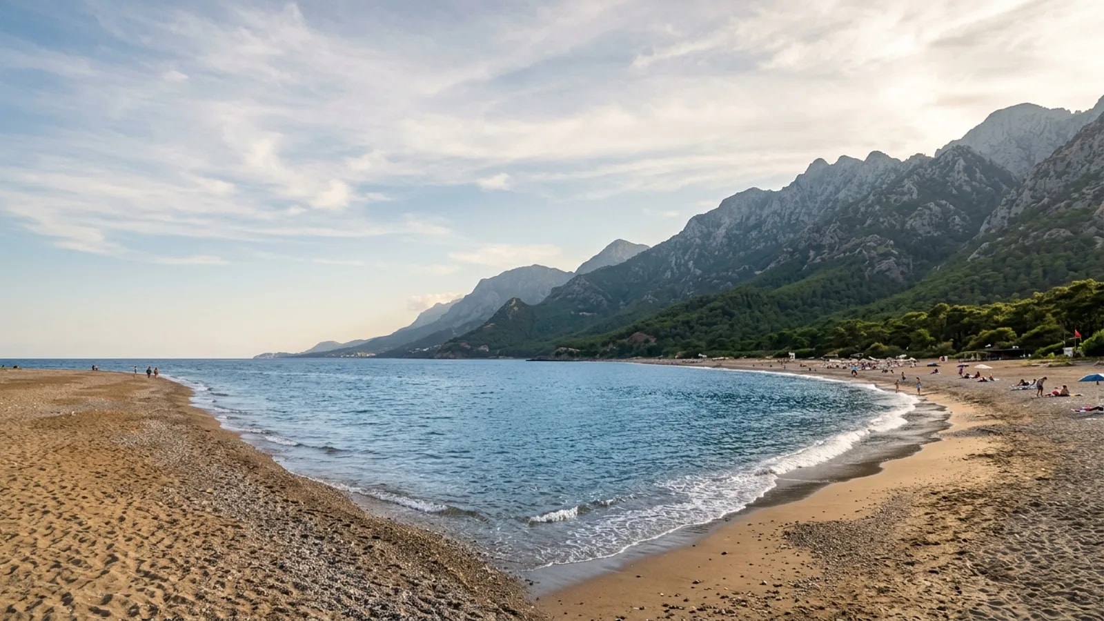 Konakli, Türkiye — the beach at Konakli west of Alanya, a long sand and shingle shore with mountains rising steeply a short way inland.